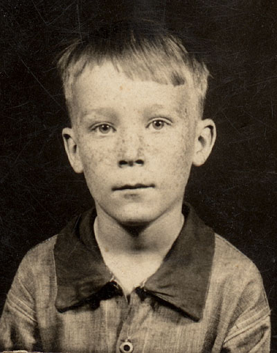 Jean Valjean at 7 Years old, with coveralls which were washed on a scrub-board and flat ironed with an iron on a wood burning stove!